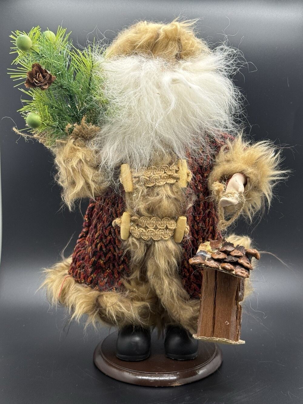 Old world style vintage santa holding birdhouse